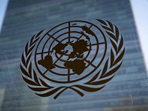 caption: The symbol of the United Nations is displayed outside the Secretariat Building at UN headquarters.
