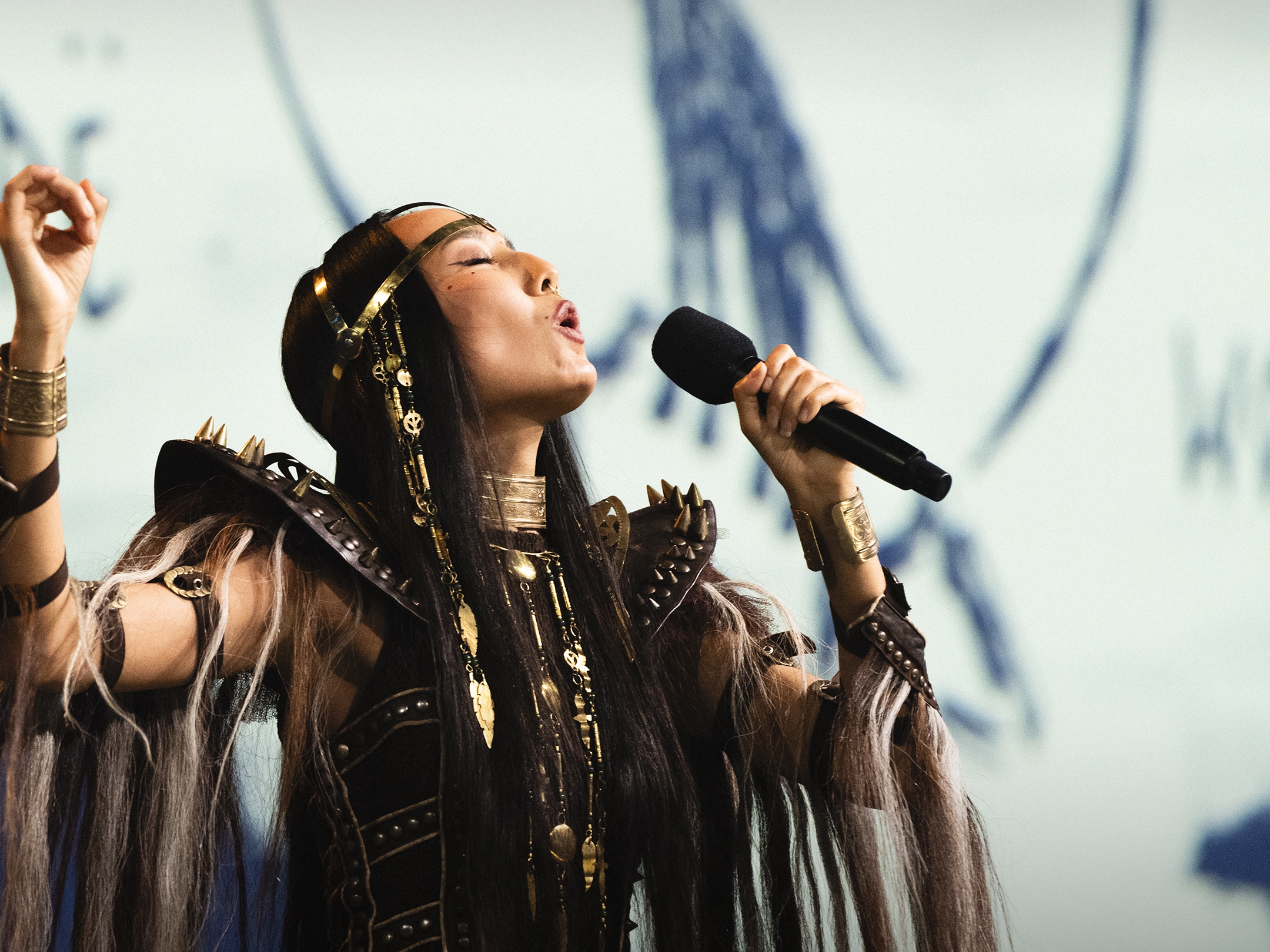 caption: Snow Raven performs at TED in 2024