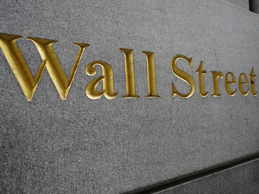 caption: "Wall Street" is etched on a building across the street from the New York Stock Exchange in September. Stocks are rallying as voters head to the polls Tuesday.