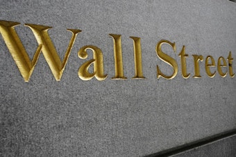 caption: "Wall Street" is etched on a building across the street from the New York Stock Exchange in September. Stocks are rallying as voters head to the polls Tuesday.