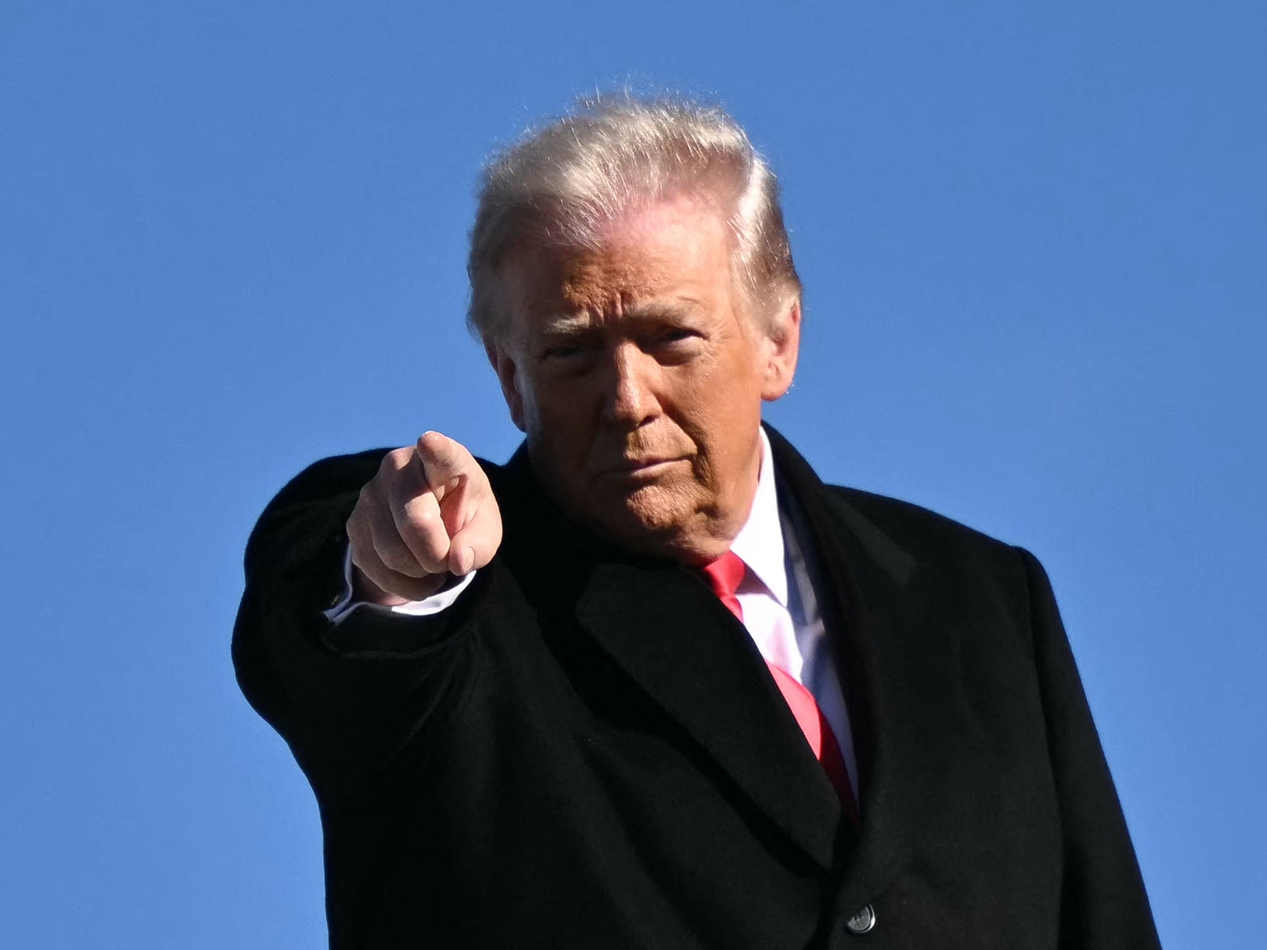 caption: President Trump gestures as he boards Air Force One on Jan. 13.