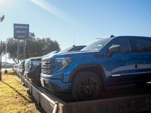 caption: GMC pickup trucks on a lot at a General Motors dealership in Austin, Texas. The average U.S. passenger vehicle has gotten about 8 inches taller in the last 30 years, according to the Insurance Institute for Highway Safety.