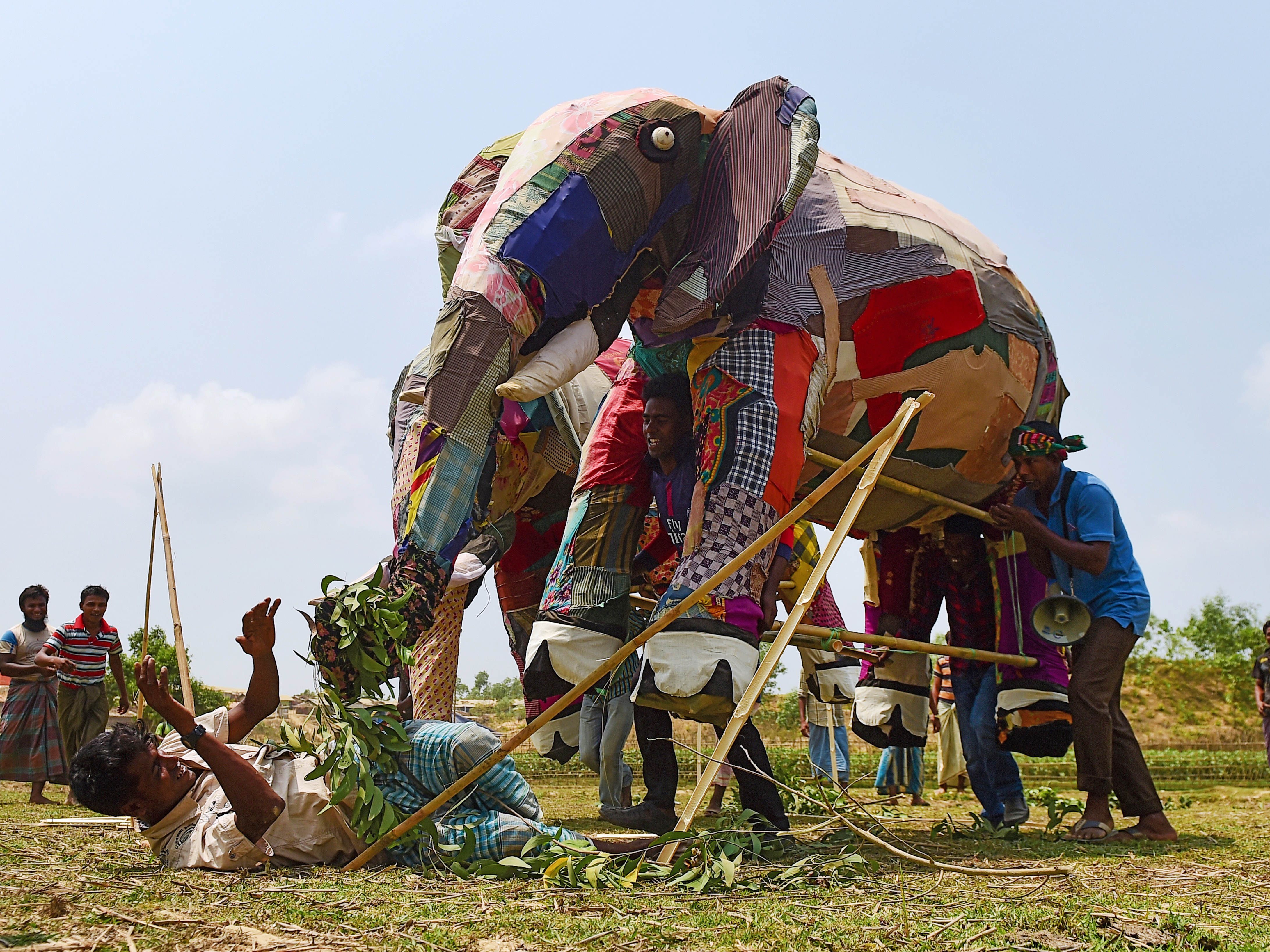 caption: Rohingya refugees use a mock elephant during a training session on how to respond to elephant incursions at the Kutupalong refugee camp. The massive refugee camp sits in what used to be a migratory path for elephants moving between Myanmar and Bangladesh.