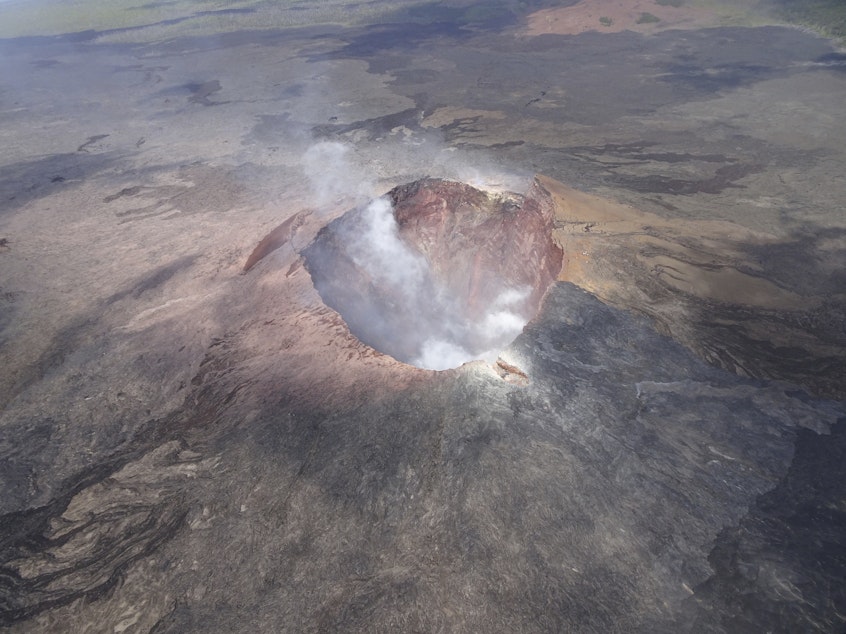 caption: Aerial image of the Puu Oo eruption site on Kilauea volcano, Hawaii Volcanoes National Park, in July 2018. The volcano is no longer erupting but is still active.