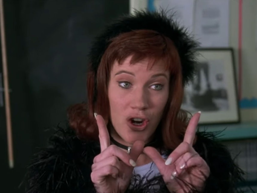 caption: The 1995 teen movie <em>Clueless</em> popularized terms like "Whatever" — including the gesture — shown here in a still featuring Elisa Donovan as Amber.