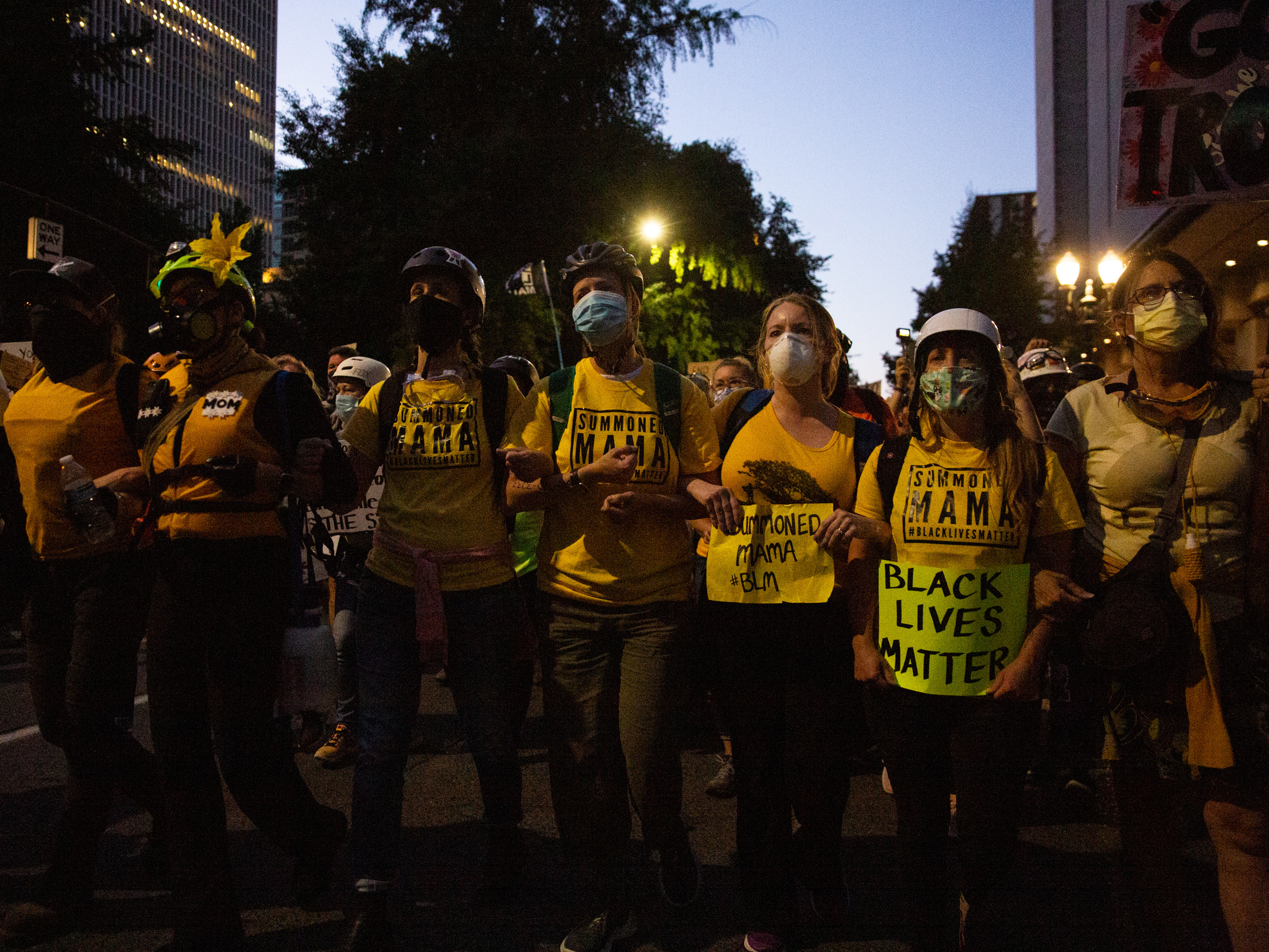 caption: The Wall of Moms marches to the Multnomah County Justice Center in Portland, Ore., July 25, 2020. Portland has sustained protests against police brutality and systemic racism for 58 days.