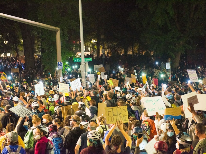 caption: Protests in Portland, shown here on July 24, have grown increasingly heated with the presence of federal agents. On Monday, groups and individual protesters sued the federal government over its response.