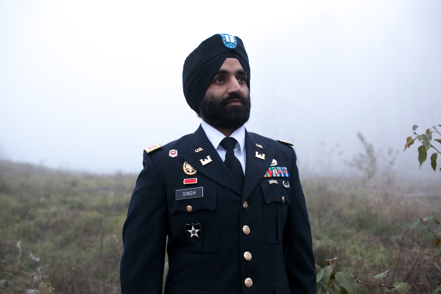 caption: Captain Simratpal Singh wearing his turban and full beard with his US Army uniform.