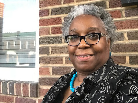 caption: Wanda<strong> </strong>Onafuwa says a house next door to her in Baltimore fell into disrepair after Bank of America foreclosed on the property.