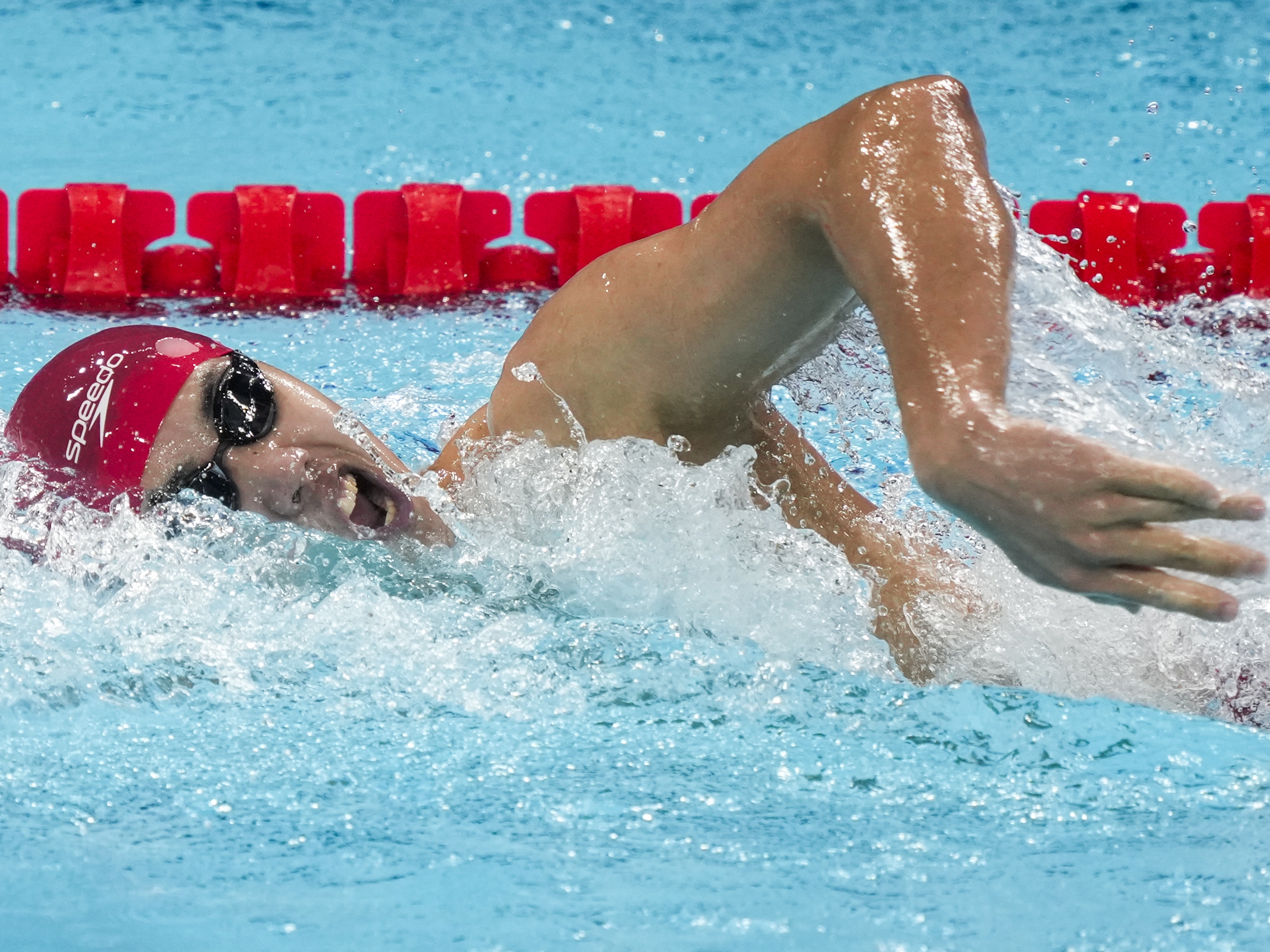 caption: Fei Liwei, of China, competes during a heat in the men's 400-meter freestyle at the 2024 Summer Olympics on Saturday in Nanterre, France. He's one of 11 Chinese swimmers competing in Paris who face questions over a 2021 sports doping case.