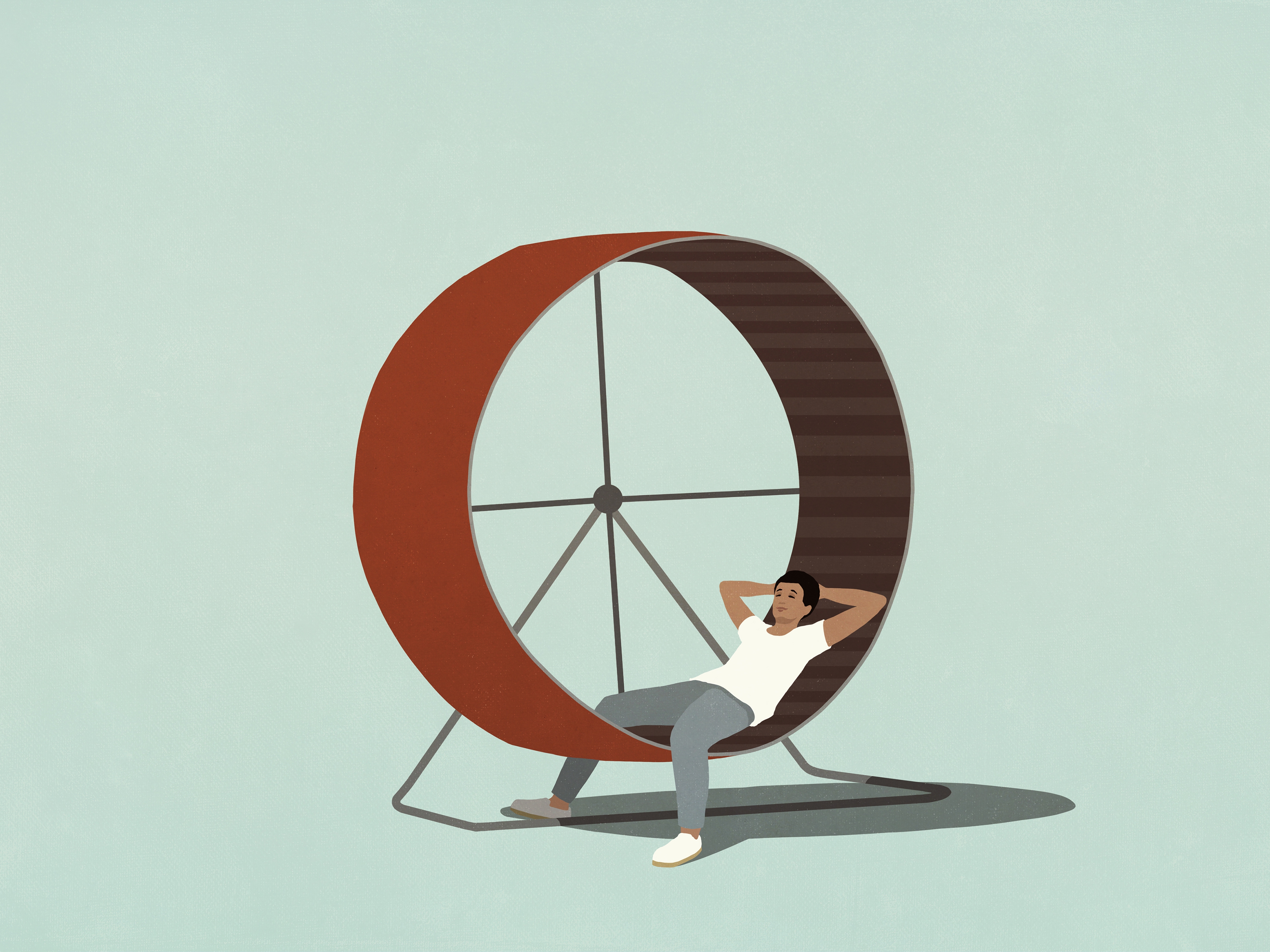 Man relaxing with hands behind head on hamster wheel