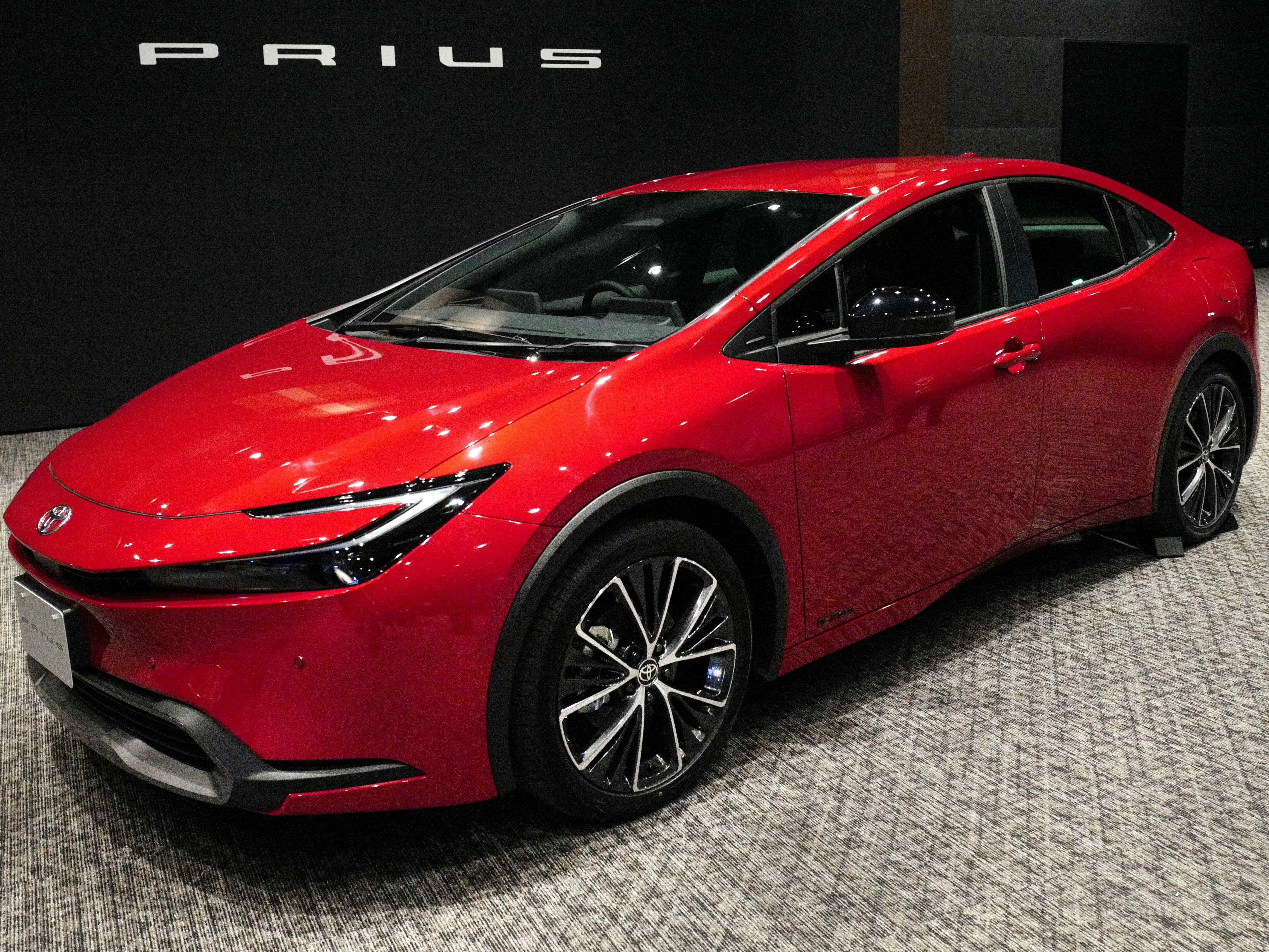 caption: Toyota unveils a new Prius during in Tokyo on Nov. 16, 2022. A quarter century after Toyota introduced the Toyota Prius, hybrids remain popular with shoppers.