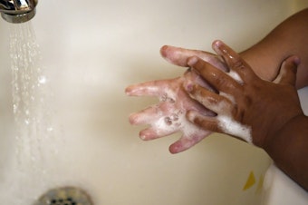 caption: A child washes her hands at a daycare center in Connecticut last month. A detailed look at COVID-19 deaths in U.S. kids and young adults by the Centers for Disease Control and Prevention shows the great majority are children of color.