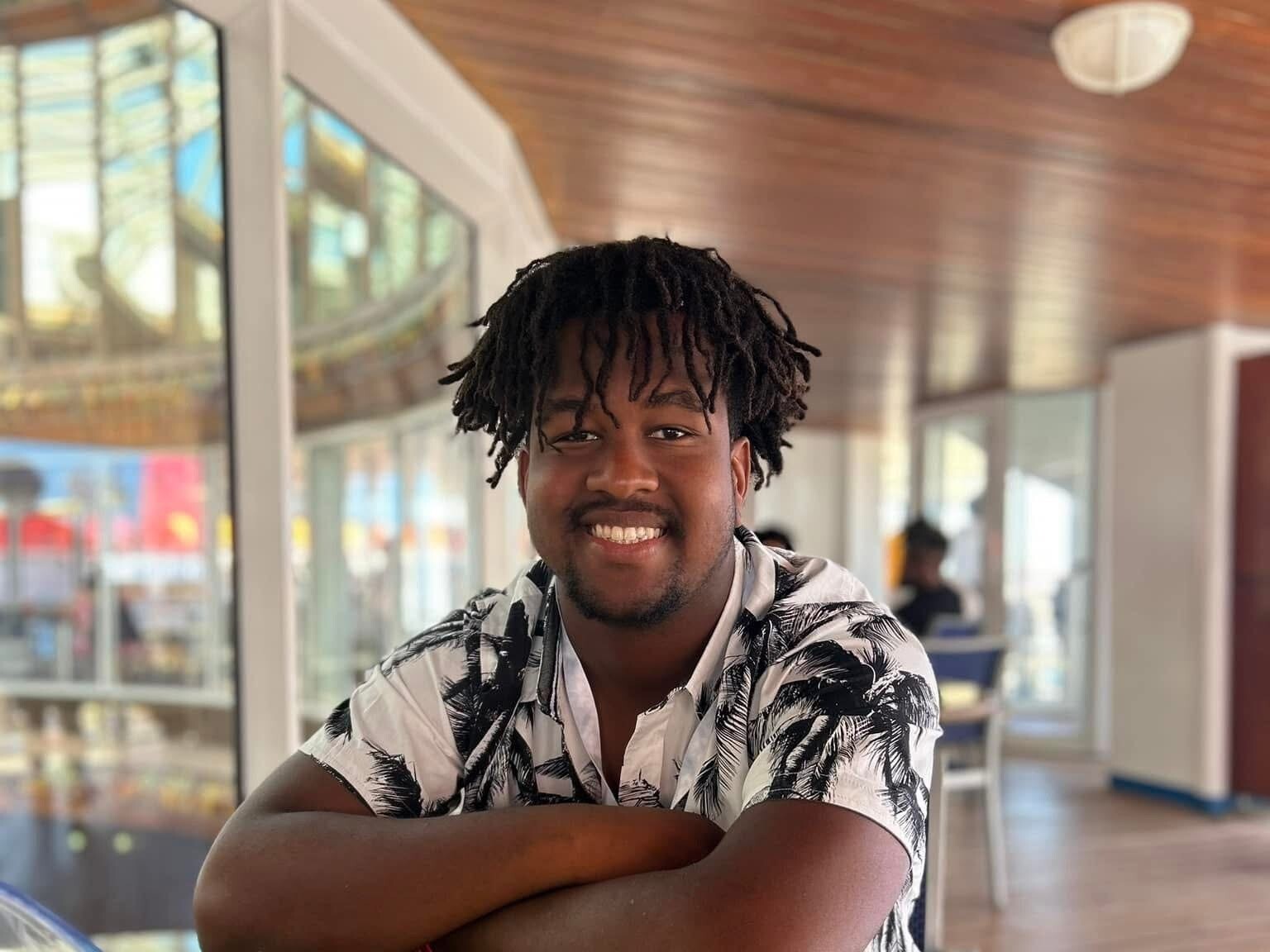 caption: Calvin "CJ" Dickey Jr. is seen on a cruise with his family in 2023. He died July 12, 2024, after his first football practice at Bucknell University.