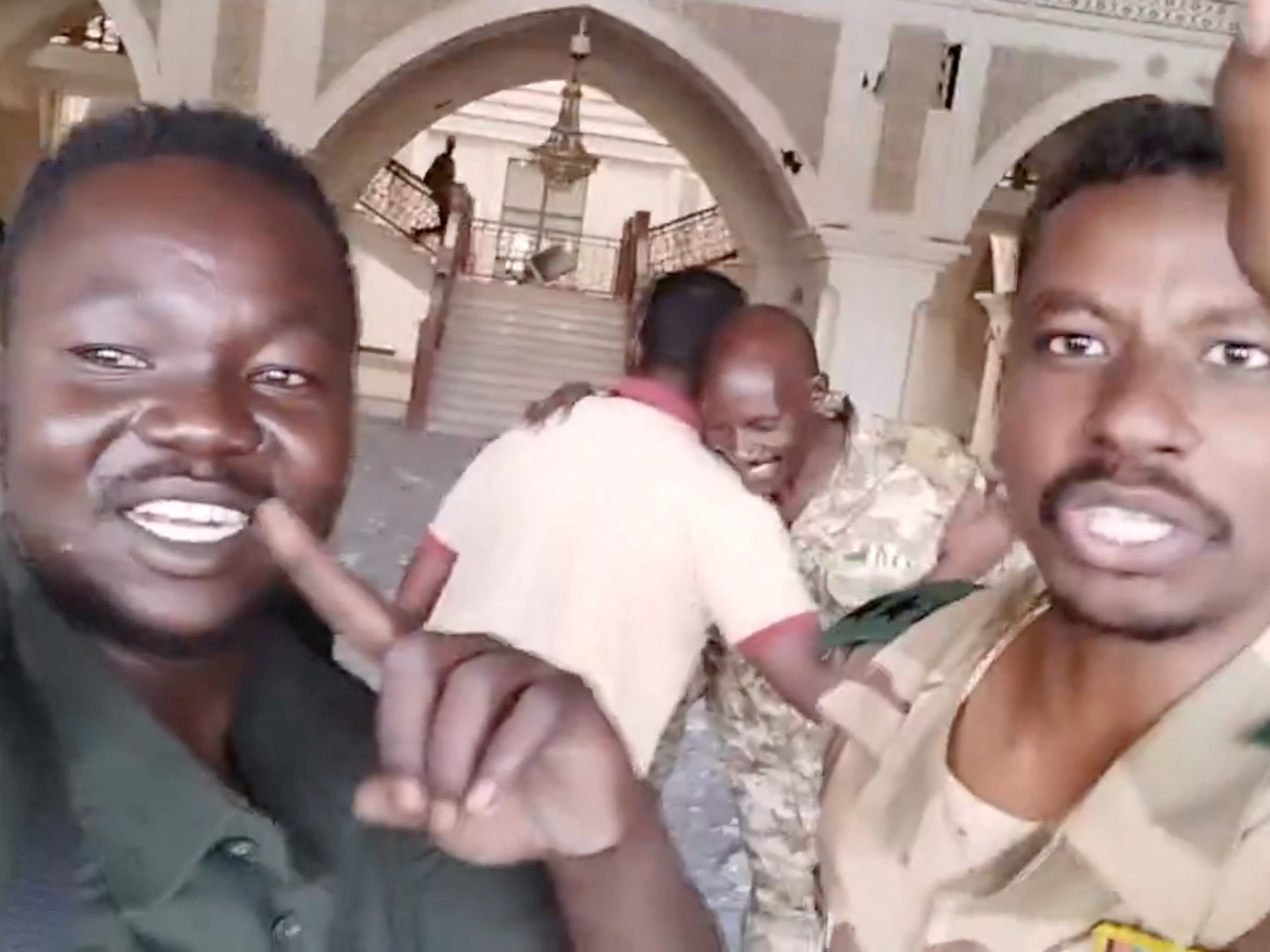 caption: Sudanese army members film themselves inside the presidential palace, as the Sudanese army says they have taken control of the building, in Khartoum, Sudan, March 21, 2025, in this screengrab obtained from a social media video.