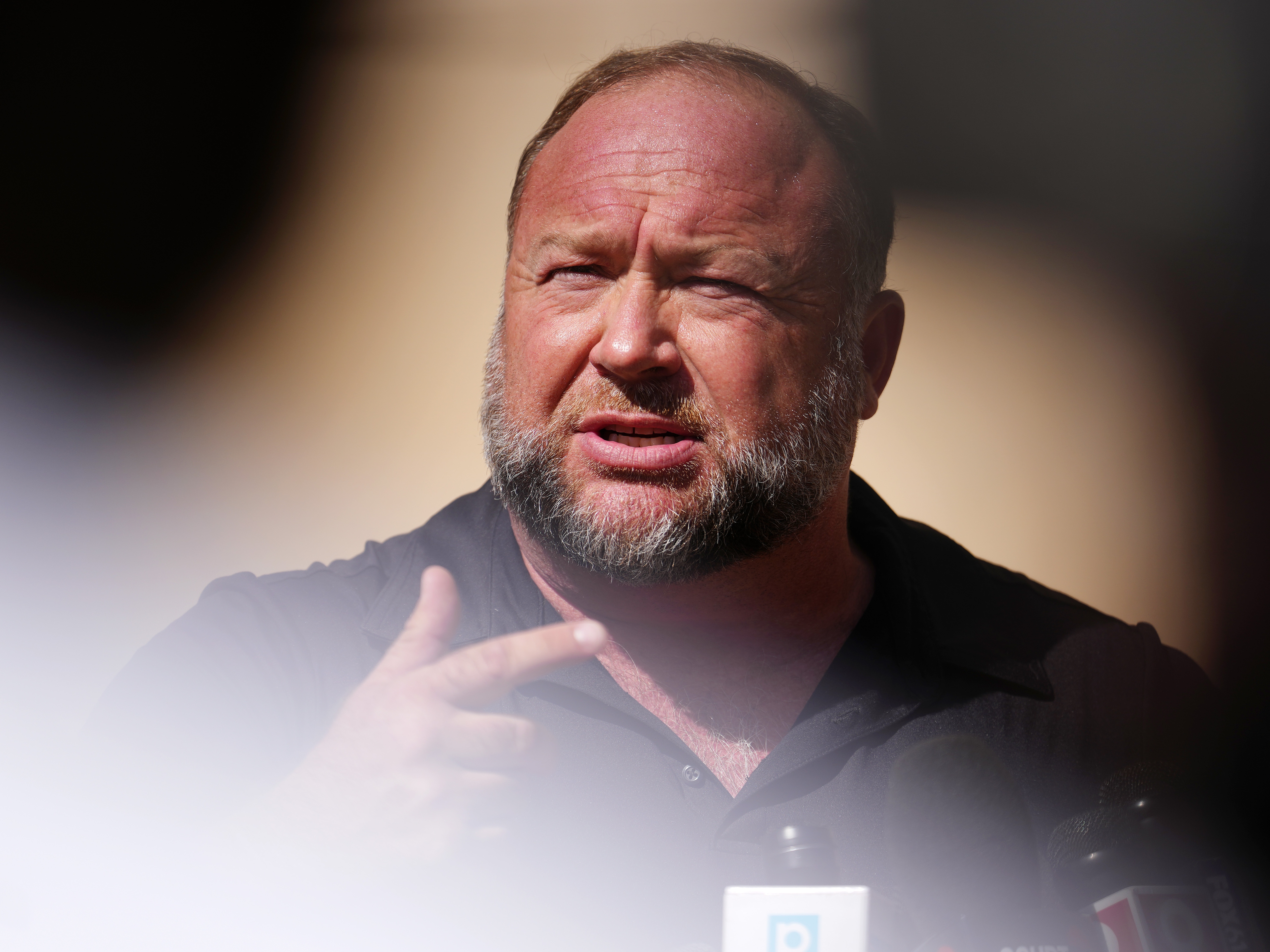 caption: Infowars founder Alex Jones speaks to the media outside Waterbury Superior Court in Waterbury, Conn., on Sept. 21, 2022. Several victims' families successfully sued Jones for causing emotional and psychological harm after they lost their children in the 2012 Sandy Hook massacre.