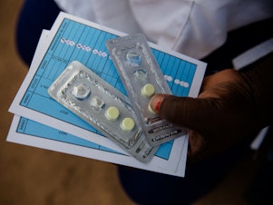 caption: Malaria Consortium providing antimalarial pills in Burkina Faso.
