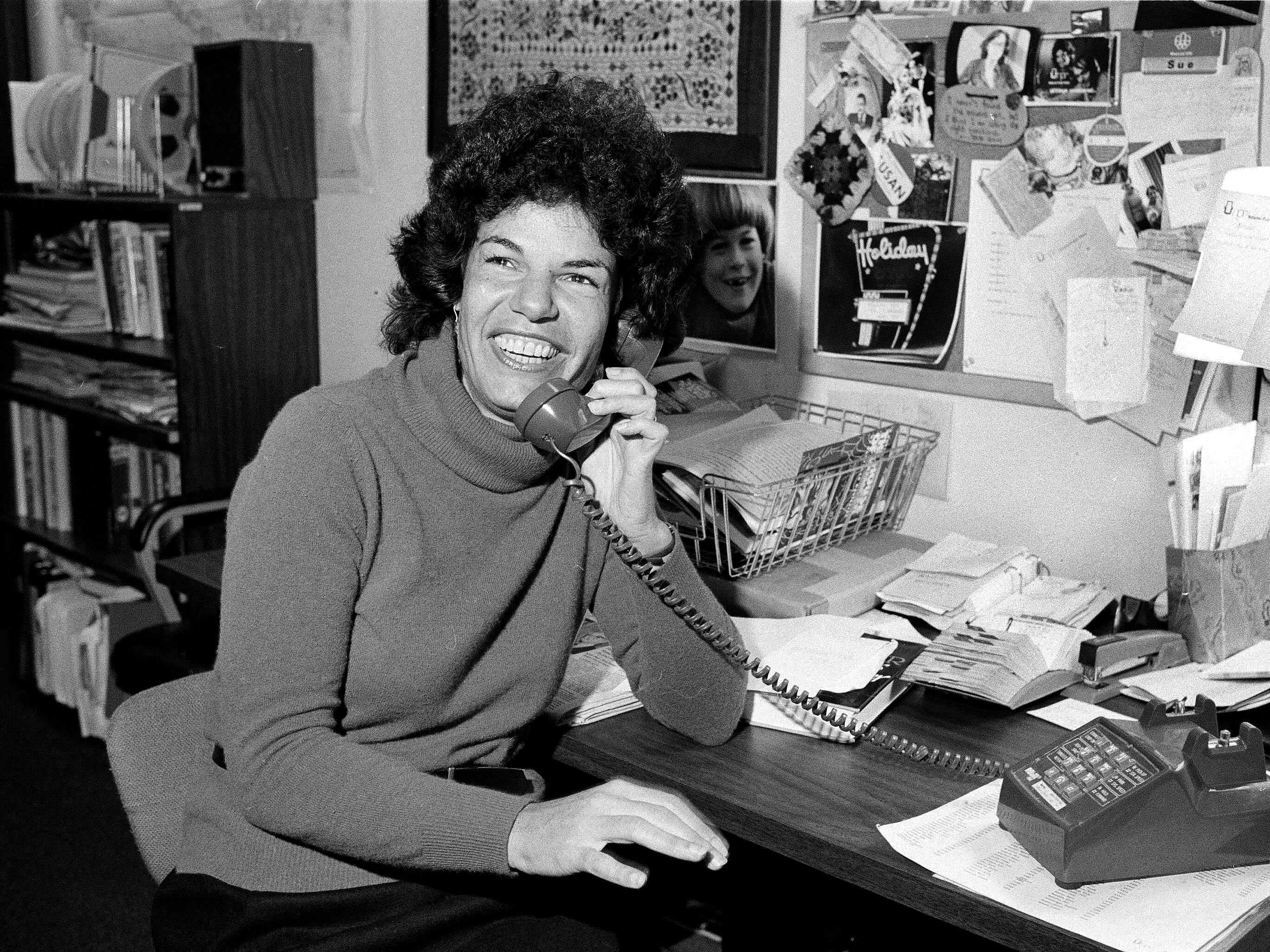 caption: National Public Radio's Susan Stamberg holds a phone in her Washington, D.C., office, Oct. 13, 1979.