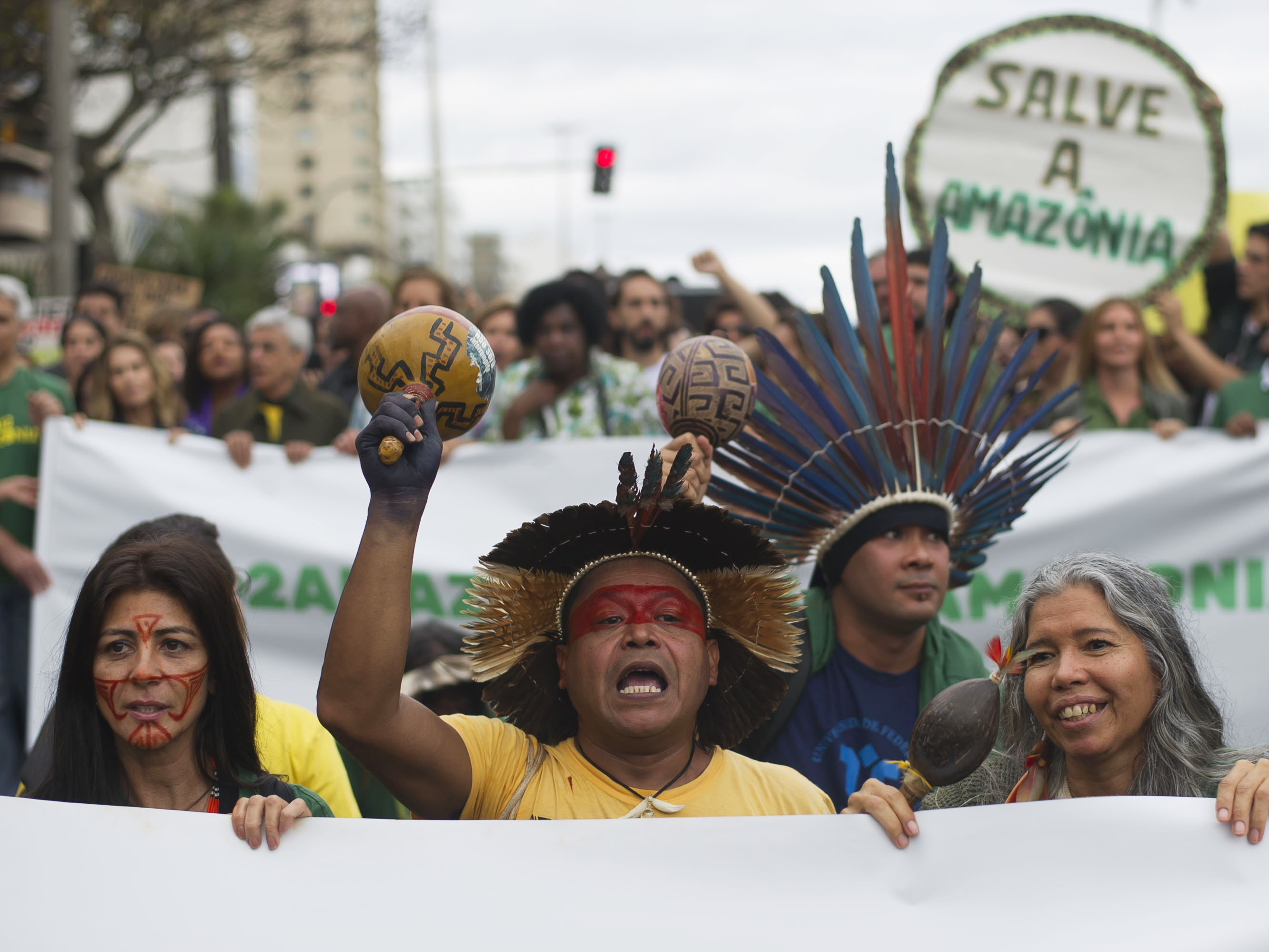 caption: Indigenous people protest in defense of the Amazon in Rio de Janeiro on Sunday. Experts from the country's satellite monitoring agency say most of the fires are set by farmers or ranchers clearing existing farmland, but the same monitoring agency has reported a sharp increase in deforestation this year as well.
