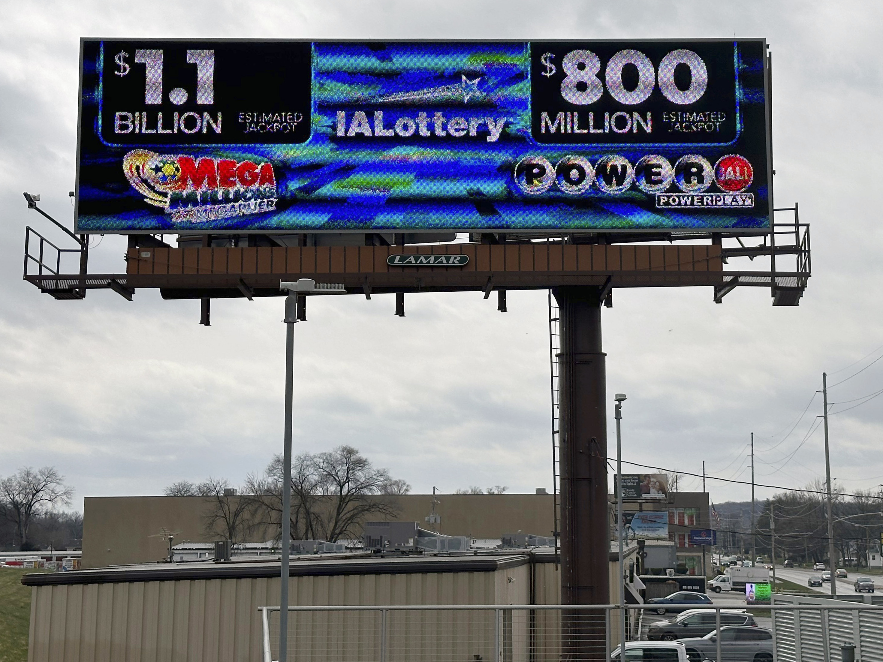 caption: An electronic billboard advertises the Mega Millions and Powerball jackpots, Monday, March 25, 2024, in in Des Moines, Iowa.