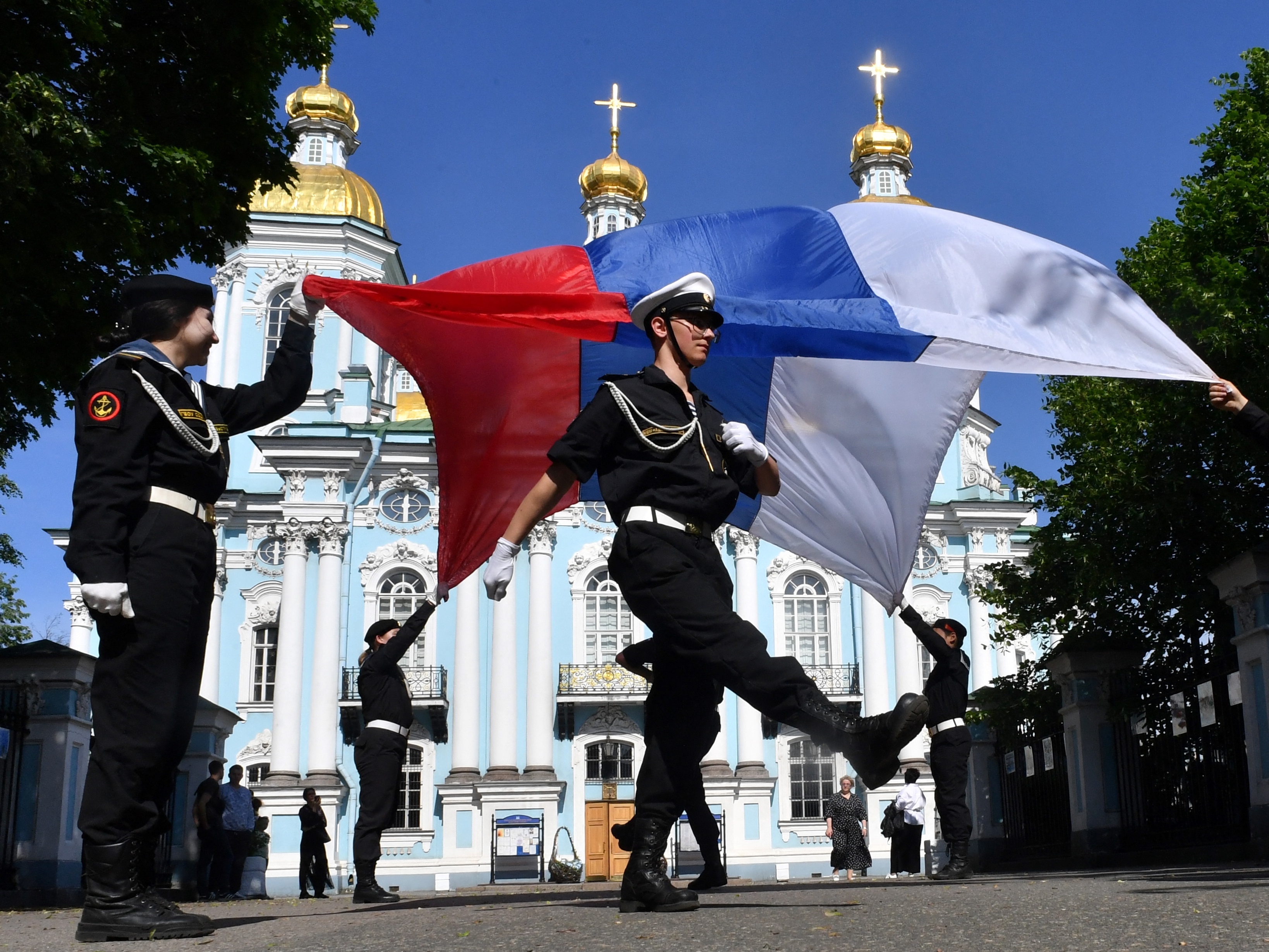 caption: Russian navy recruits perform with the Russian flag in St. Petersburg, Russia, on June 4 during a ceremony marking the departure of recruits to join the army. In a year filled with elections around the world, Russia has stepped up its overt and covert propaganda efforts with a goal of weakening international support for Ukraine and undermining democratic institutions.
