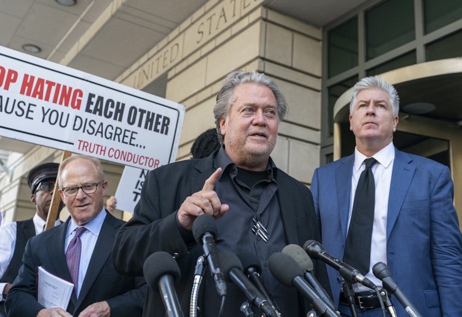 caption: Former White House strategist Steve Bannon, center, speaks with reporters as he departs federal court on Friday, July 22, 2022, in Washington. 
