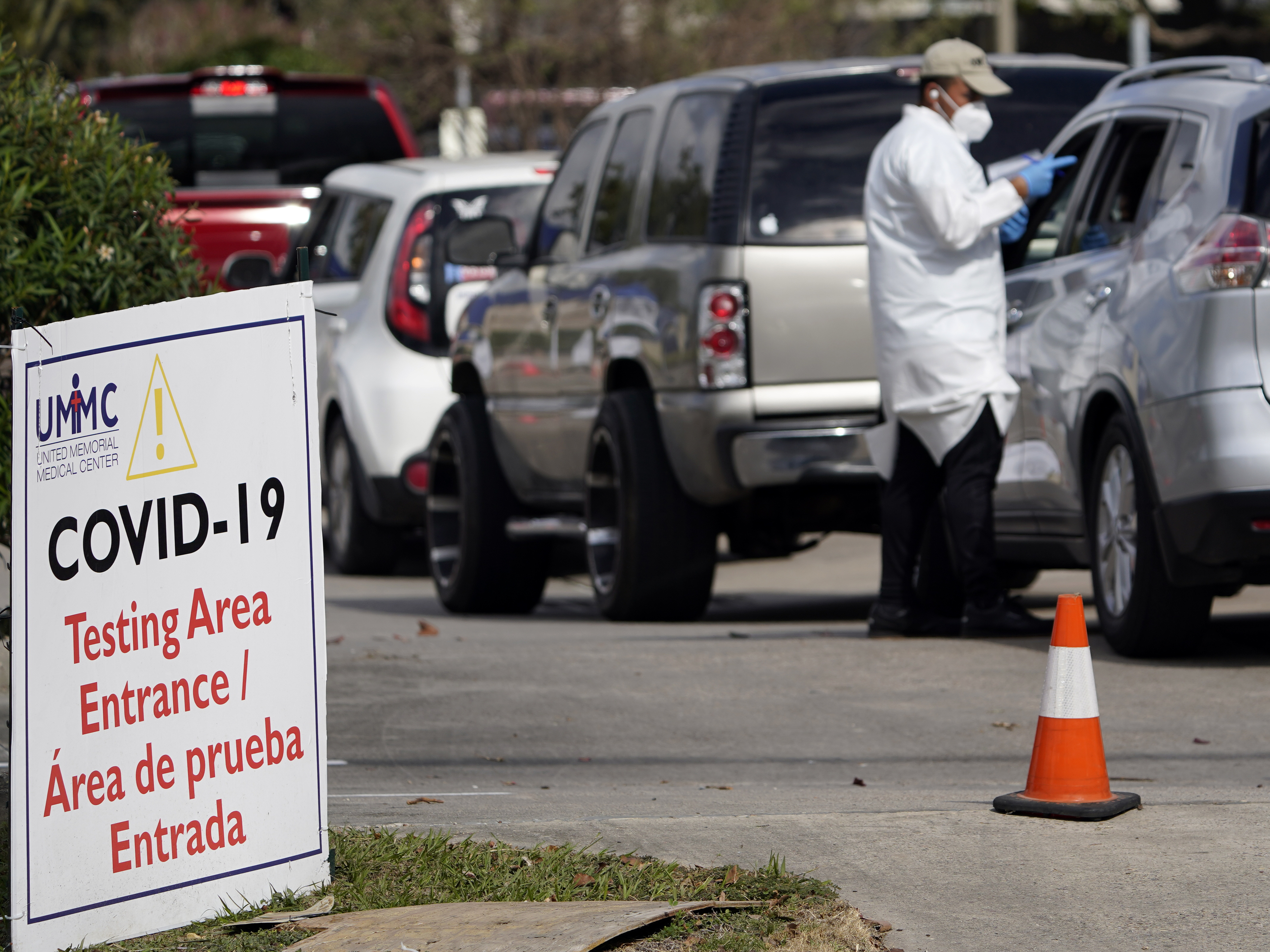 caption: A healthcare worker processes people in line at a United Memorial Medical Center COVID-19 testing site on Nov. 19, in Houston. Texas is rushing thousands of additional medical staff to overworked hospitals as the number of hospitalized COVID-19 patients increases.