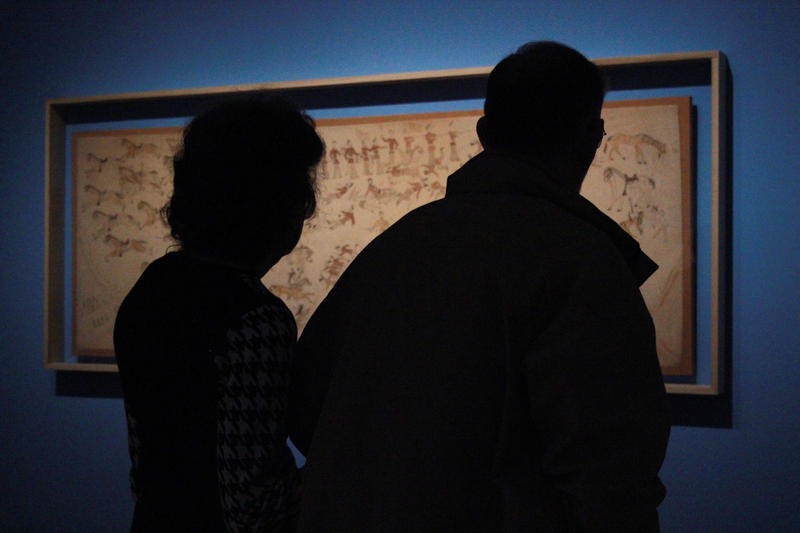 caption: Donnie Wilburn, who is blind, and her husband Bob Wilburn observe a depiction of the Battle of Little Bighorn at the Seattle Art Museum with the help of a vivid description from museum docent laureate Suzanne Ragen.