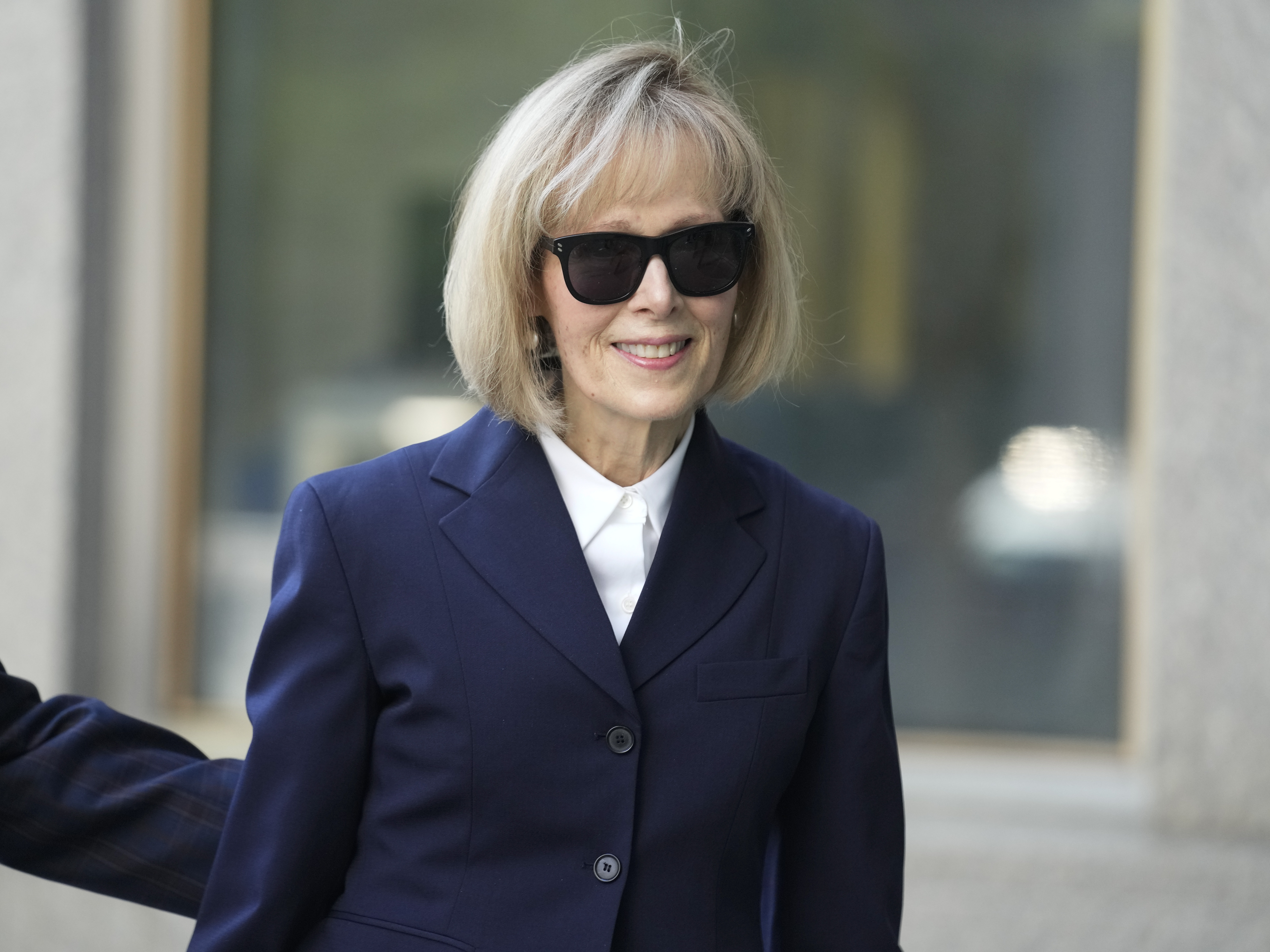 caption: Former advice columnist E. Jean Carroll arrives to federal court in New York on Wednesday. Jurors have been seated in the trial over Carroll's claim that former President Donald Trump raped her nearly three decades ago in a department store dressing room.