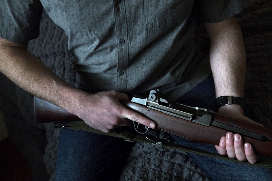caption: FILE: A Seattle gun owner holds his M1 Garand firearm on Friday, February 21, 2020, at his home.