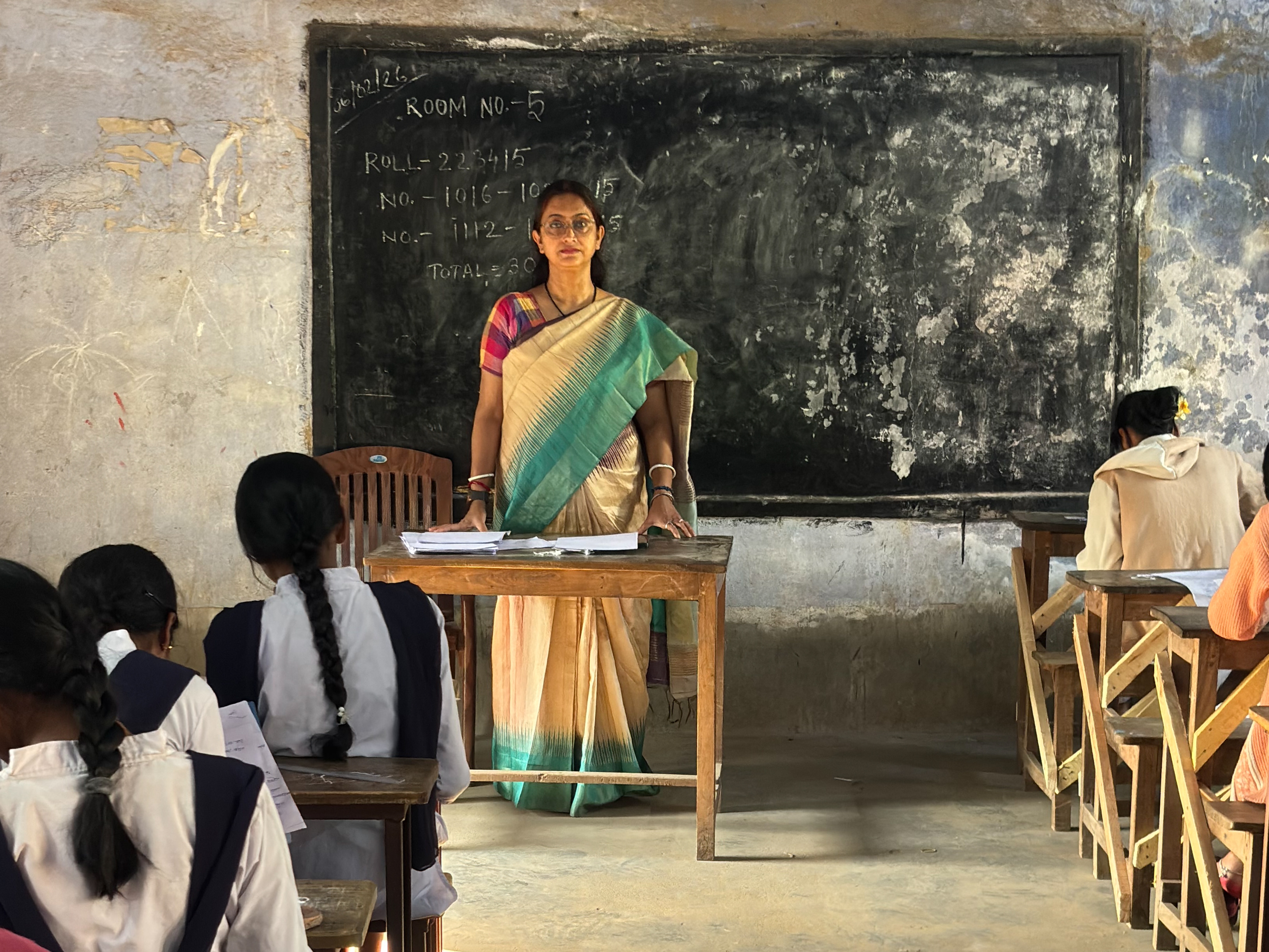 caption: Joyeeta Banerjee in her classroom in India. She is an English teacher from Bankura, a district in a rural area of West Bengal, India. For 24 years she has taught first-generation learners — children who speak Bengali or Santali at home.