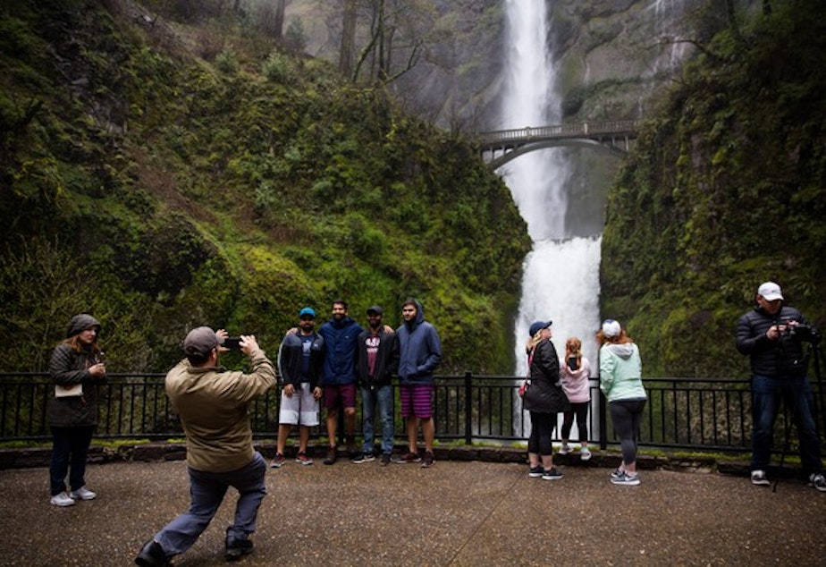 caption: <p>Tourists take pictures next to Multnomah Falls, April 13, 2018.</p>