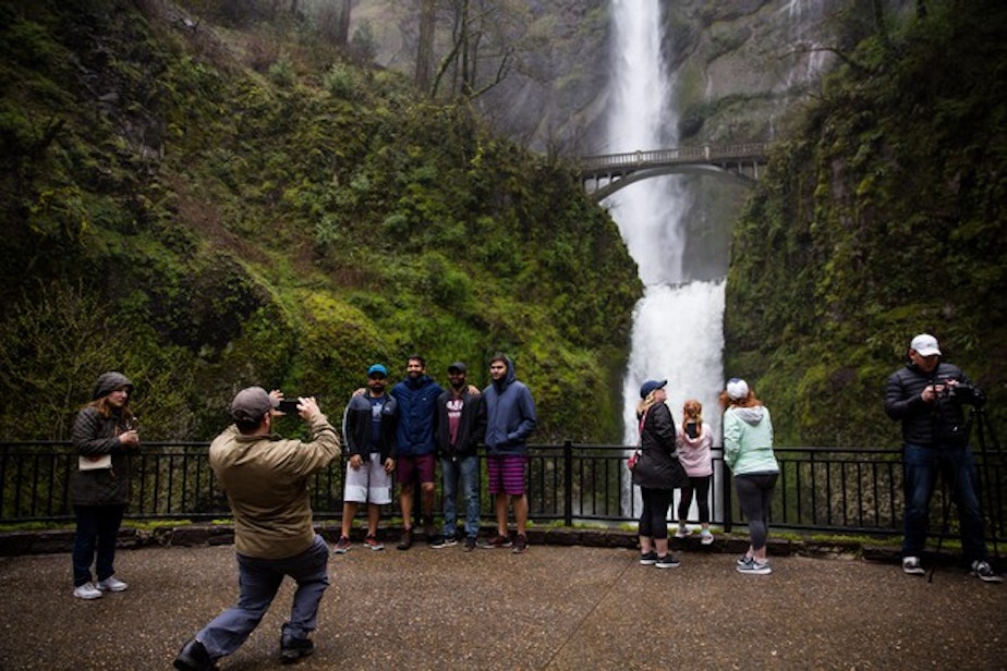 caption: <p>Tourists take pictures next to Multnomah Falls, April 13, 2018.</p>