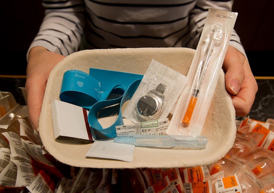 caption: Registered nurse Sammy Mullally holds a tray of supplies to be used by a drug addict at the Insite safe injection clinic in Vancouver, B.C., on Wednesday May 11, 2011.