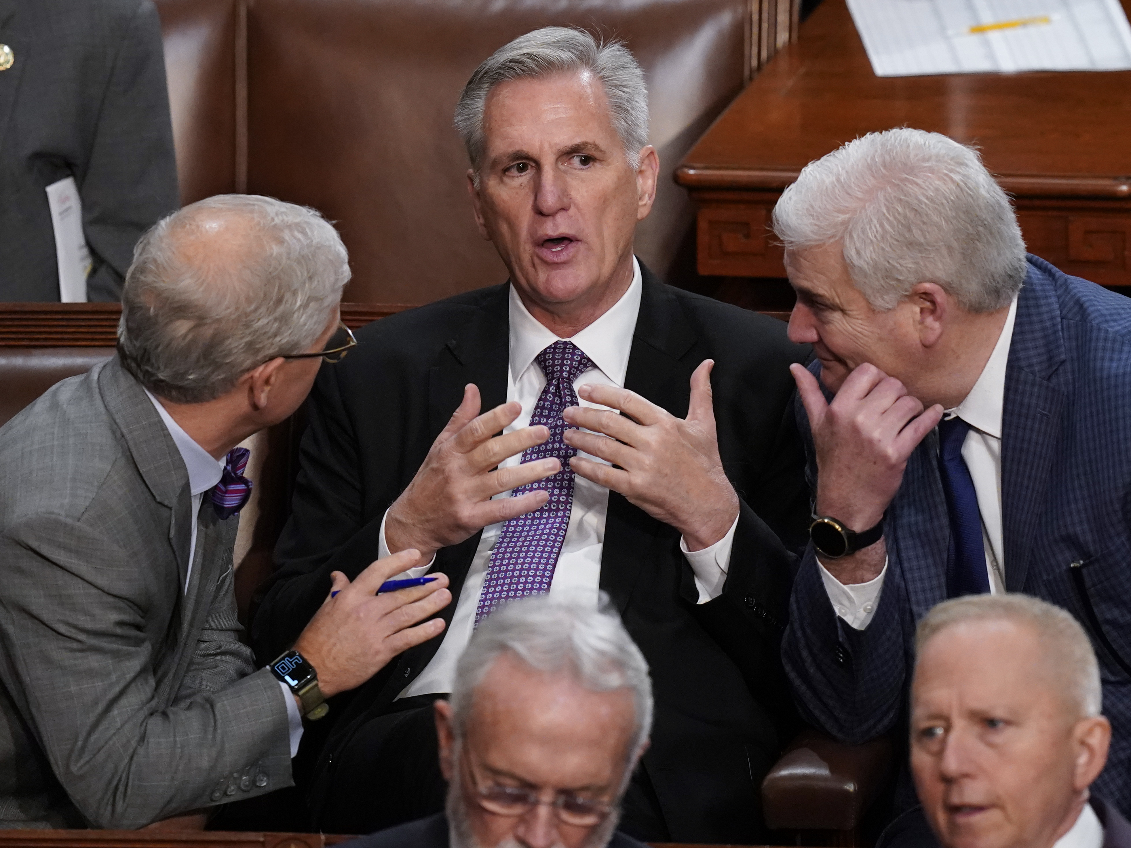 caption: Rep. Kevin McCarthy, R-Calif., is flanked by Rep. Patrick McHenry, R-N.C., left, and Rep. Tom Emmer, R-Minn., right, in the House chamber as lawmakers meet for a second day to elect a speaker and convene the 118th Congress.