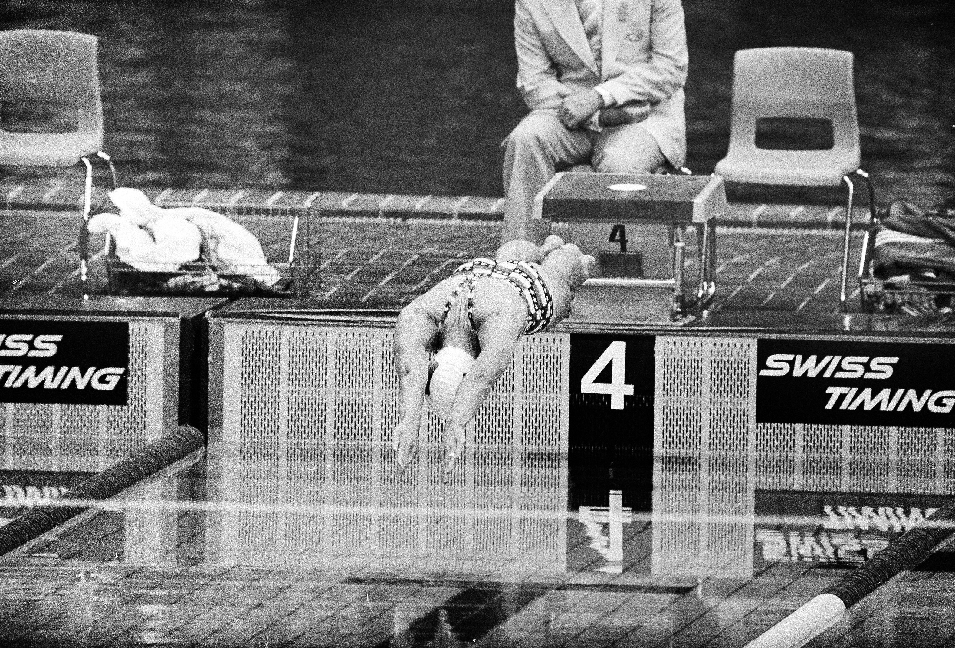 caption: U.S. swimmer Wendy Boglioli dives in to the pool to begin the second heat in the women's 100 meter butterfly competition at the Olympic pool in Montreal, Canada, July 21, 1976. 