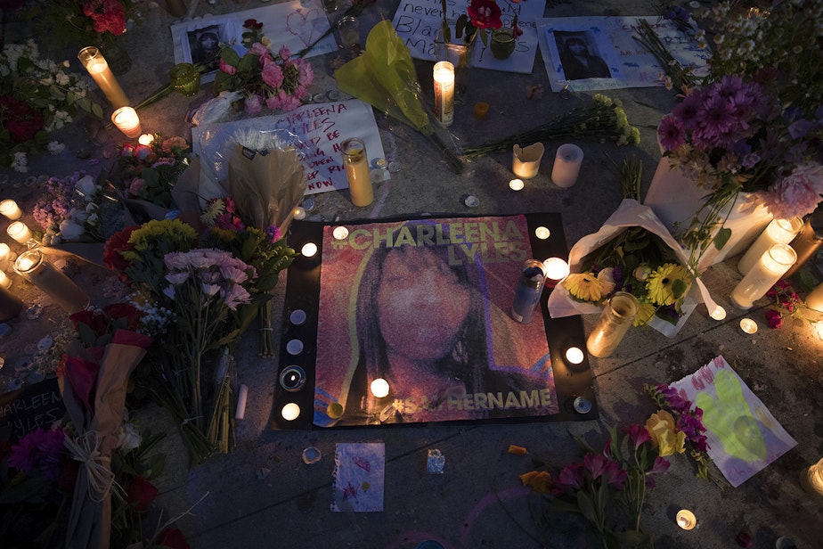 caption: Candles surround a photograph of Charleena Lyles after a vigil was held at Solid Ground Brettler Family Place on Tuesday, June 19, 2017, in Seattle, Washington. 