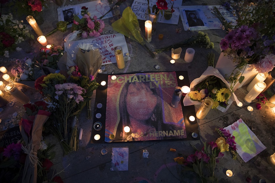 caption: Candles surround a photograph of Charleena Lyles after a vigil was held at Solid Ground Brettler Family Place on Tuesday, June 19, 2017, in Seattle, Washington.
