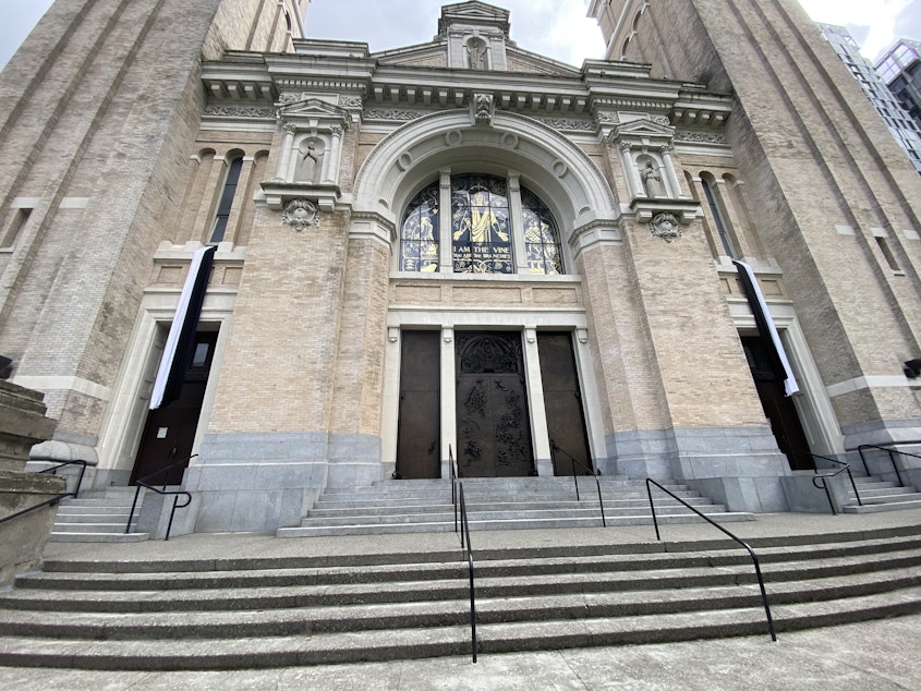 caption: The front entrance of St. James Cathedral in Seattle displays black and white bunting following the death of Pope Francis on April 21, 2025.
