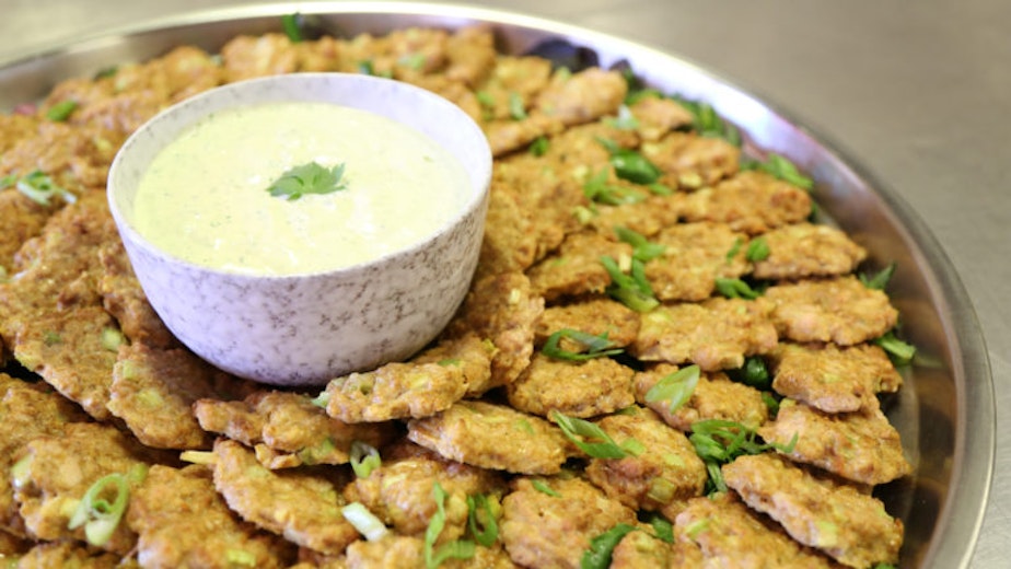caption: A platter of curry chicken patties made with ground chicken, celery, onions and curry blend.