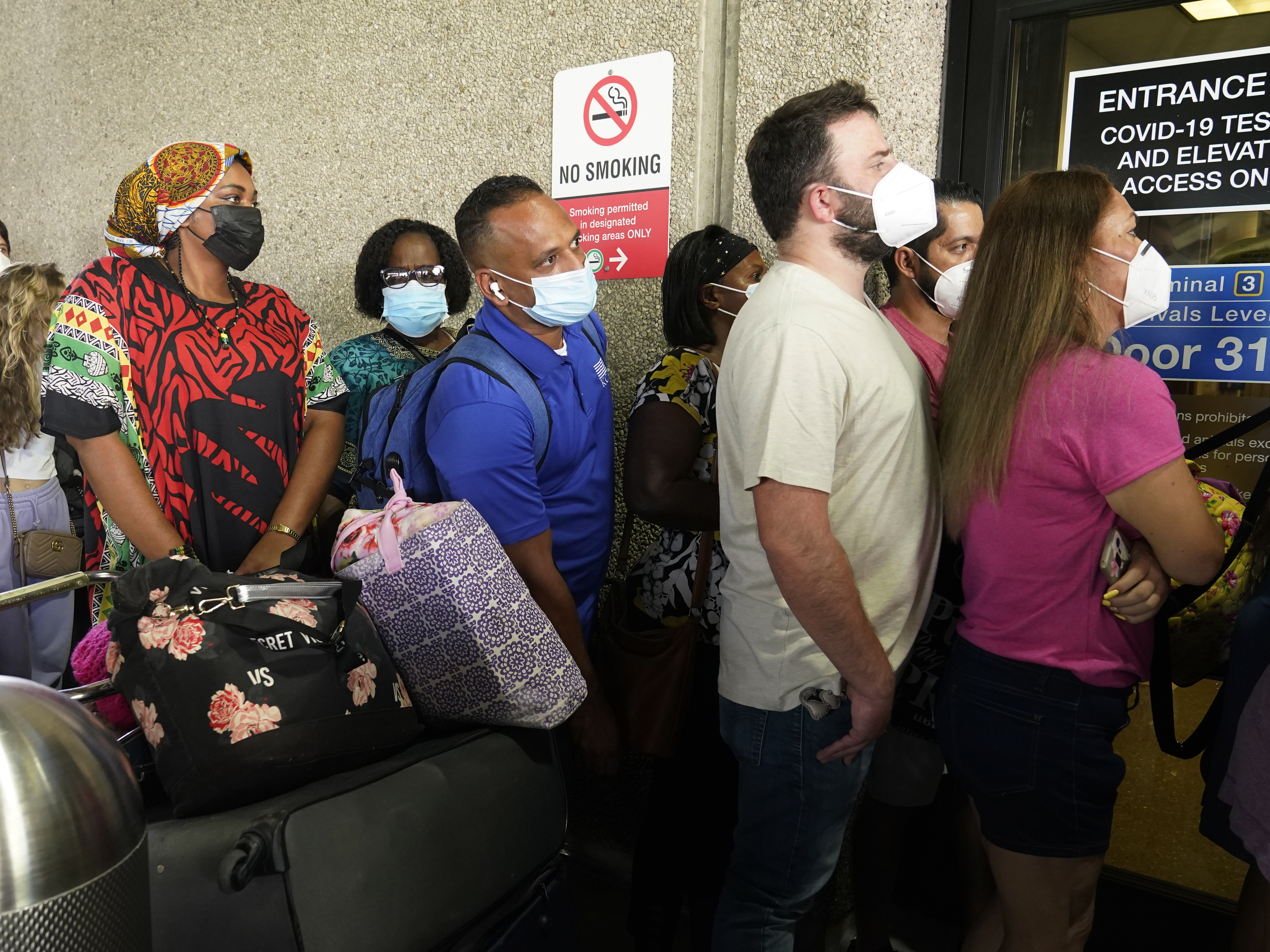 caption: Passengers wait in a long line to get a COVID-19 test to travel overseas at Fort Lauderdale-Hollywood International Airport on Friday in Fort Lauderdale, Fla. Recent flight cancelations caused many passengers to redo their tests while others were unable to get the test locally due to long lines caused by the surge of the delta variant.