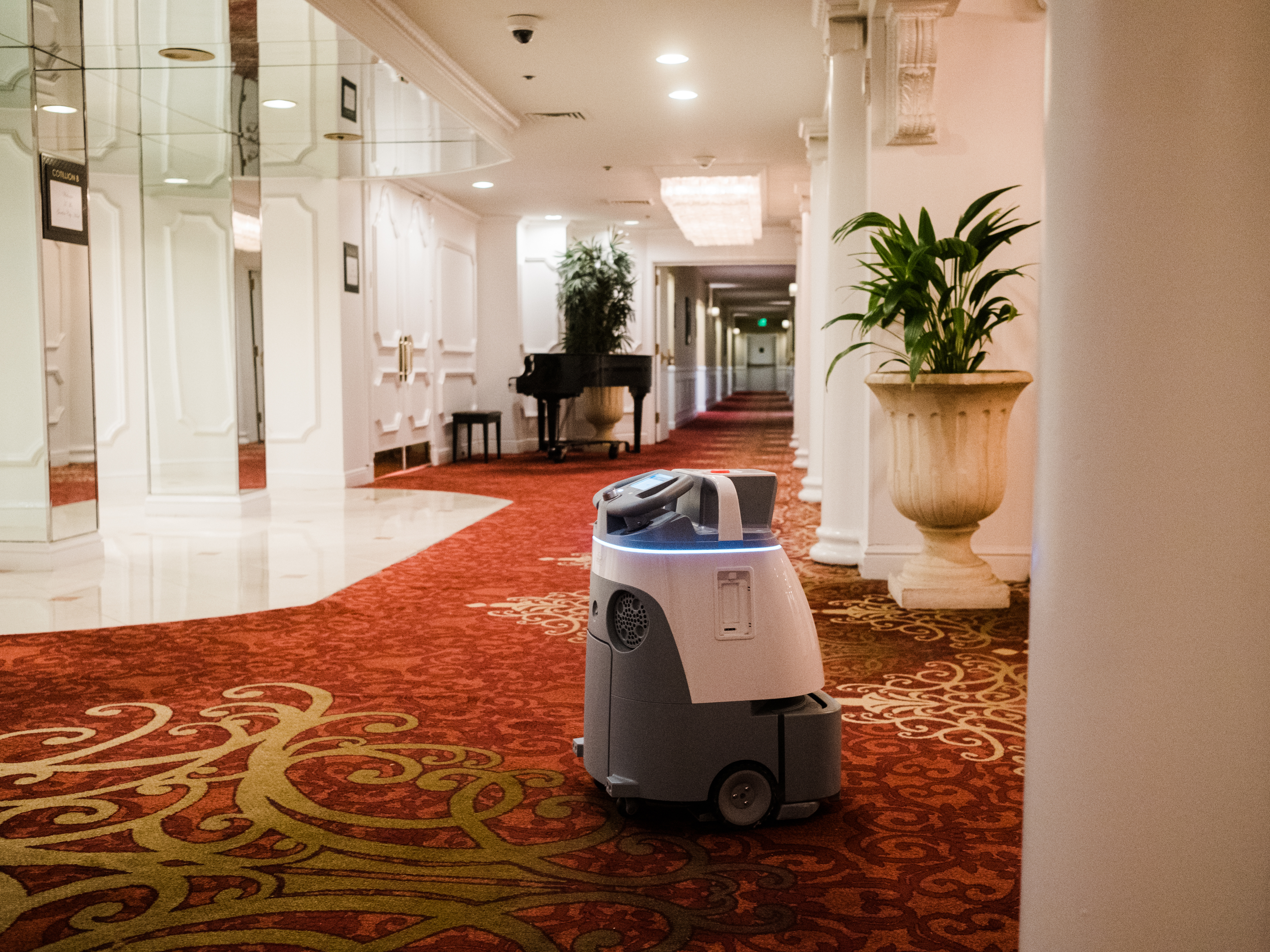 caption: The Garden City Hotel on Long Island invested in two robot vacuums in late 2021. The autonomous vacuums allow the hotel to redeploy staff to other tasks that must be done by hand.