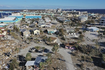 caption: In this aerial view, the destruction left in the wake of Hurricane Ian is shown on October 02, 2022 in Fort Myers Beach, Florida. The state's home insurance market is reeling after disasters like this one.
