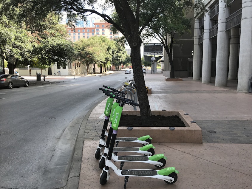 caption: LimeBike electric scooters in Austin, TX.