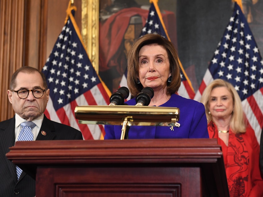 caption: House Speaker Nancy Pelosi and the chairs of investigative committees announce the articles of impeachment against President Trump on Tuesday.