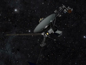 caption: This artist concept shows a NASA Voyager spacecraft traveling through the darkness of space.