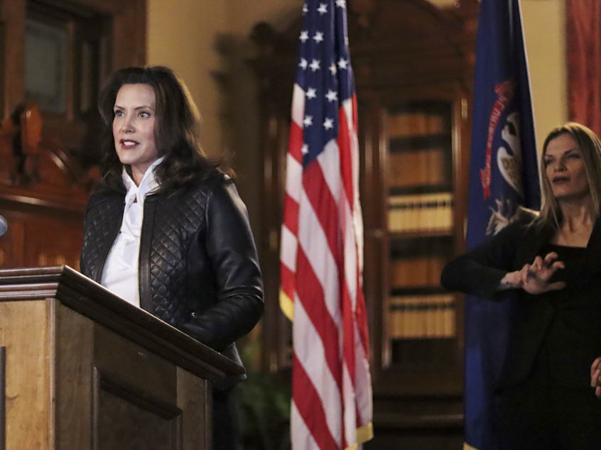 caption: Michigan Gov. Gretchen Whitmer addresses the state during a speech Thursday in Lansing. Thirteen members of two militia groups face criminal charges after allegedly plotting to kidnap Whitmer.