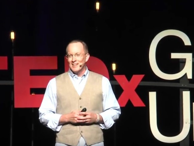 caption: Greg Tonkinson on the TED stage.