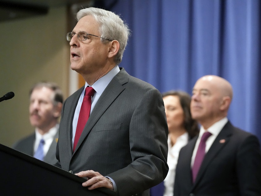 caption: Attorney General Merrick Garland speaks with reporters during a news conference at the Department of Justice on Wednesday as Secretary of Homeland Security Alejandro Mayorkas, right, looks on.