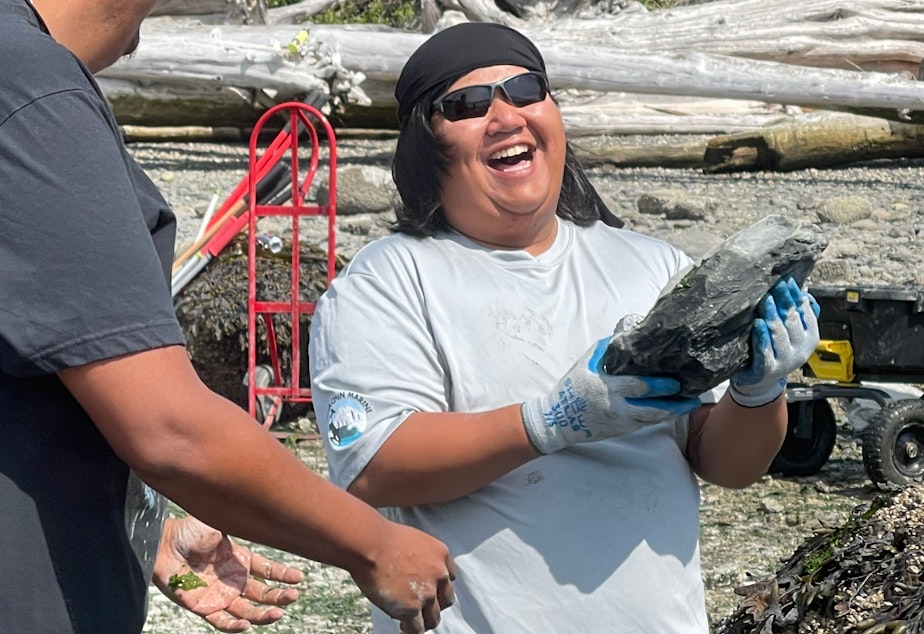Photo of Michael Sheena of the Pauquachin First Nation, in North Saanich, British Columbia, helps the Swinomish Tribe build a rock wall on Kiket Island, Washington, on Aug. 12.
